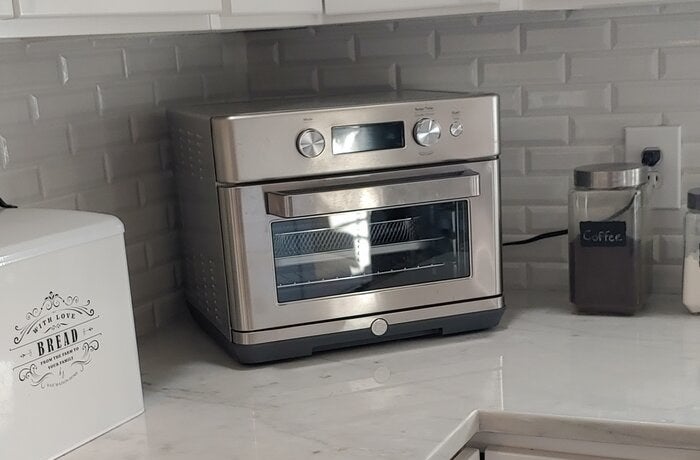 a reviewer photo of the toaster oven air fryer on a kitchen counter