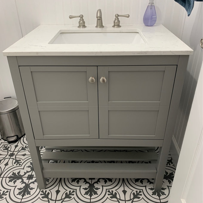 a reviewer photo of the gray vanity in a bathroom