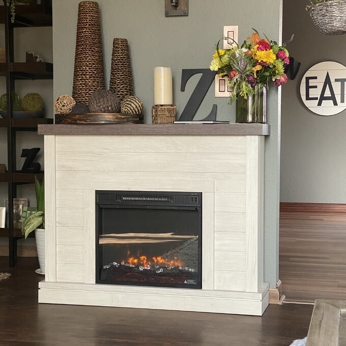 a reviewer photo of the electric fireplace in white
