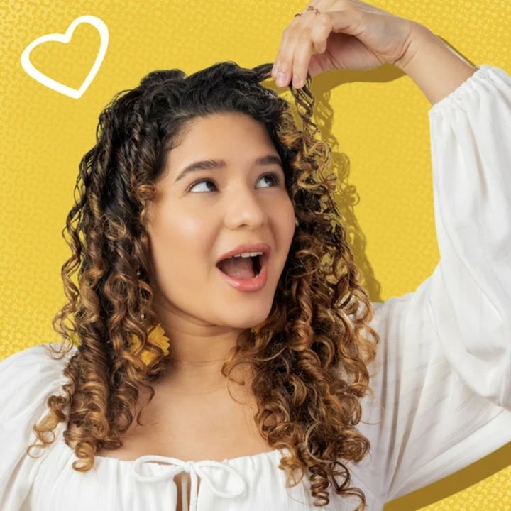 A person showing off their curly hair
