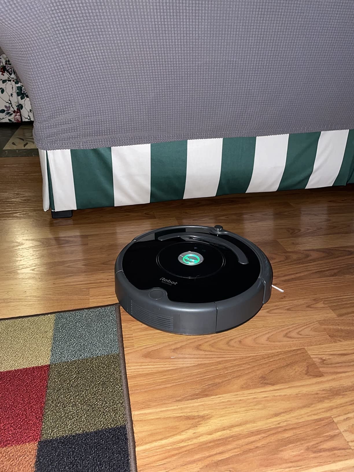 a reviewer&#x27;s robot vacuum on the floor