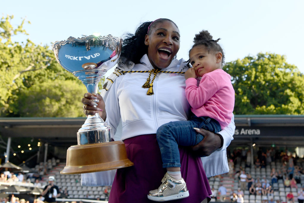 Serena holding a trophy and her daughter