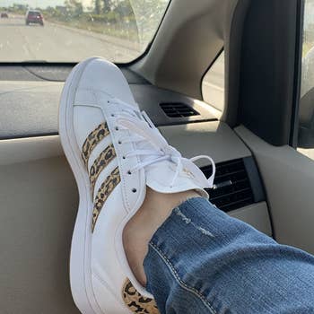 Reviewer pic of the white sneakers with cheetah printed stripes on the side