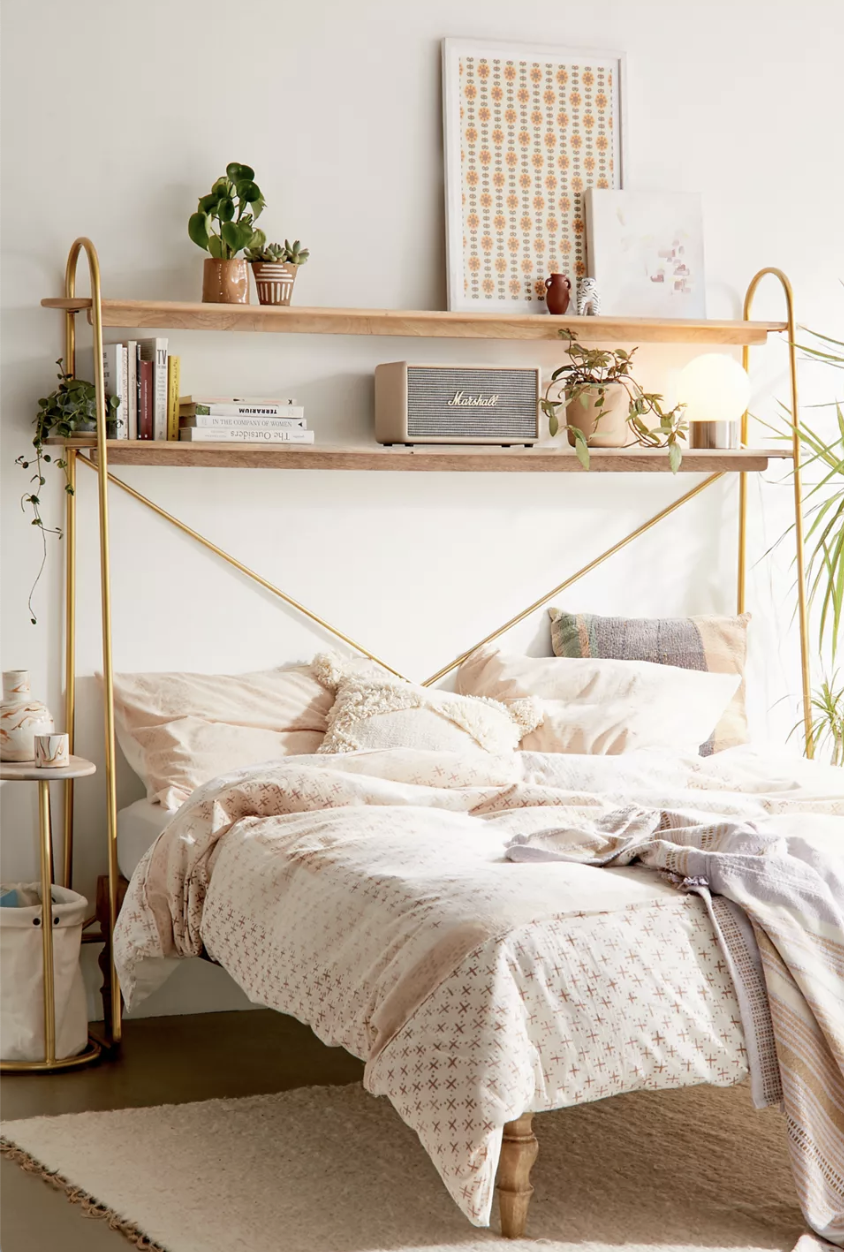 gold headboard with two wood shelves