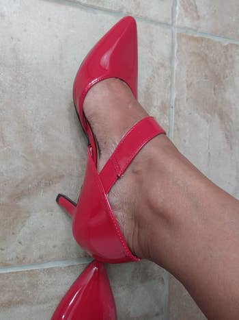 Reviewer pic of them wearing the shoes in a shiny red