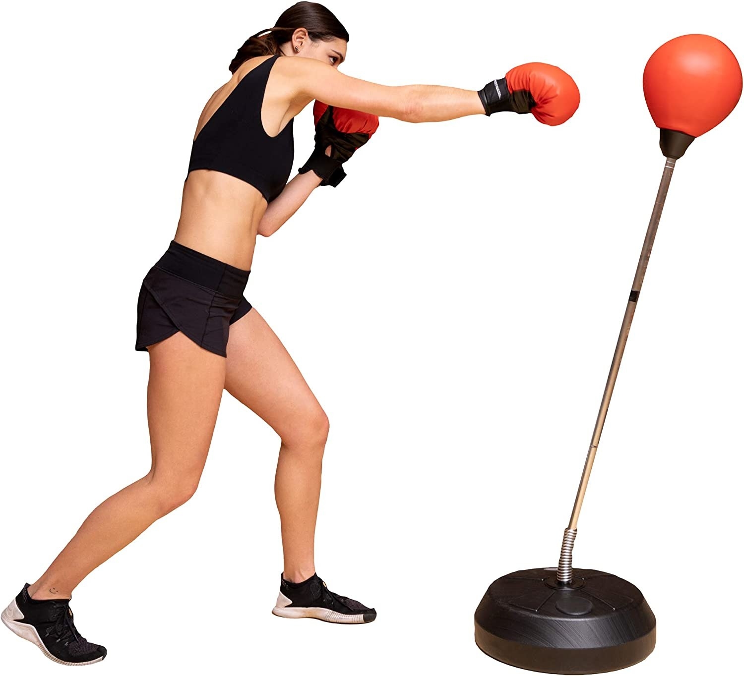 Model boxing with a red punching bag stand
