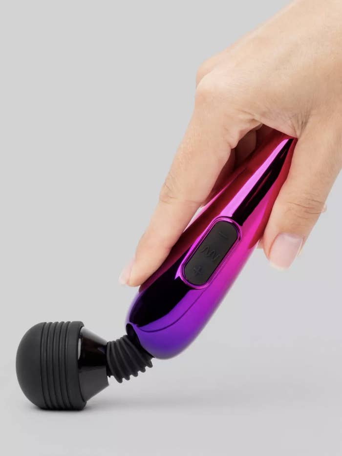 The metallic purple-pink ombre wand with flexible neck being bent down on surface