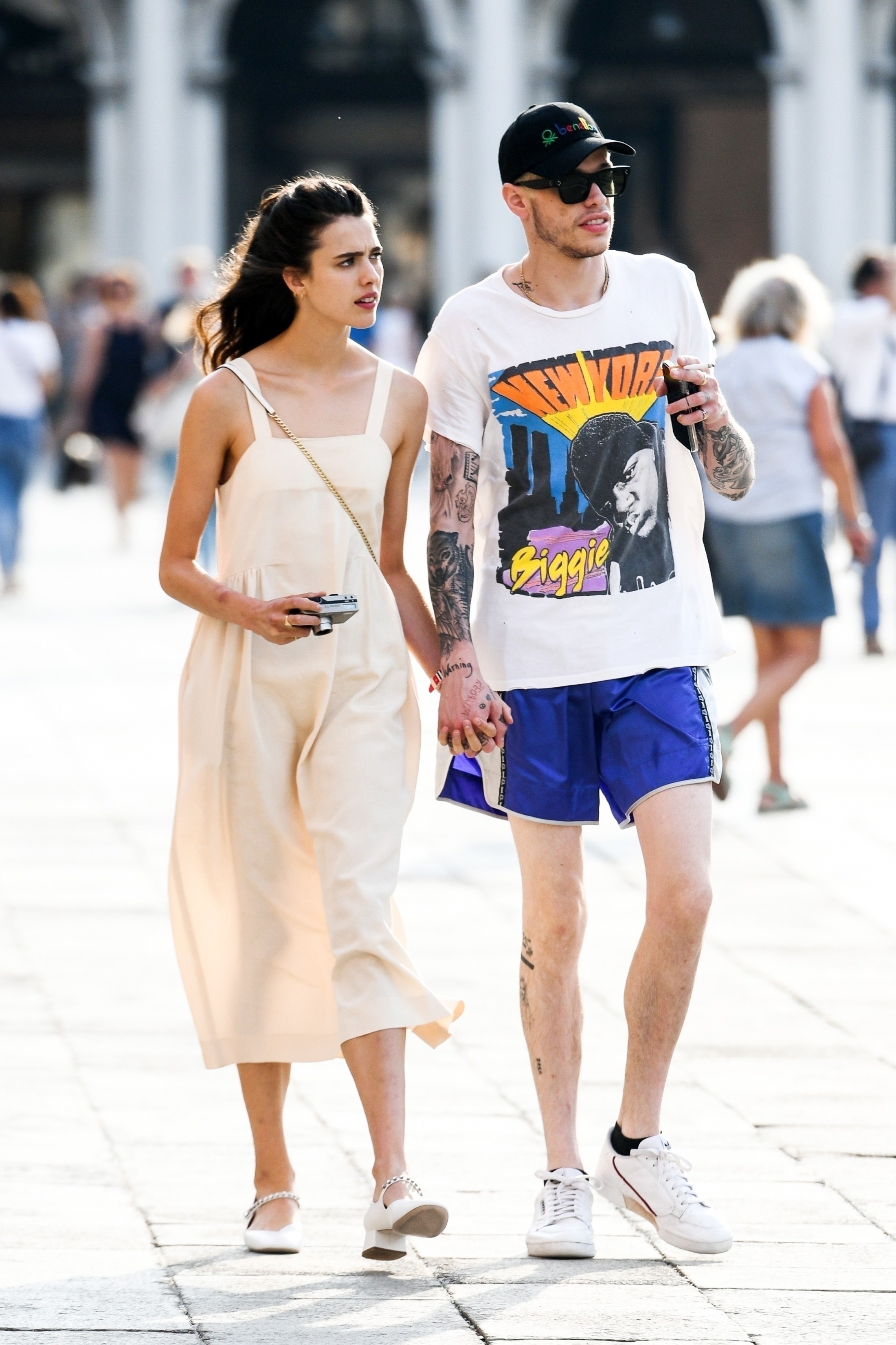 Margaret Qualley and Pete holding hands as they take a stroll