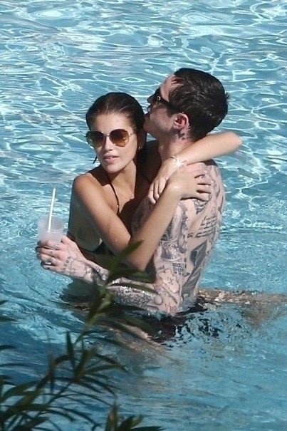 Kaia and Pete holding each other in a pool