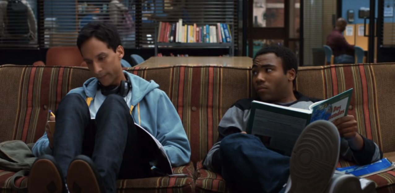 young guys sitting on a couch studying