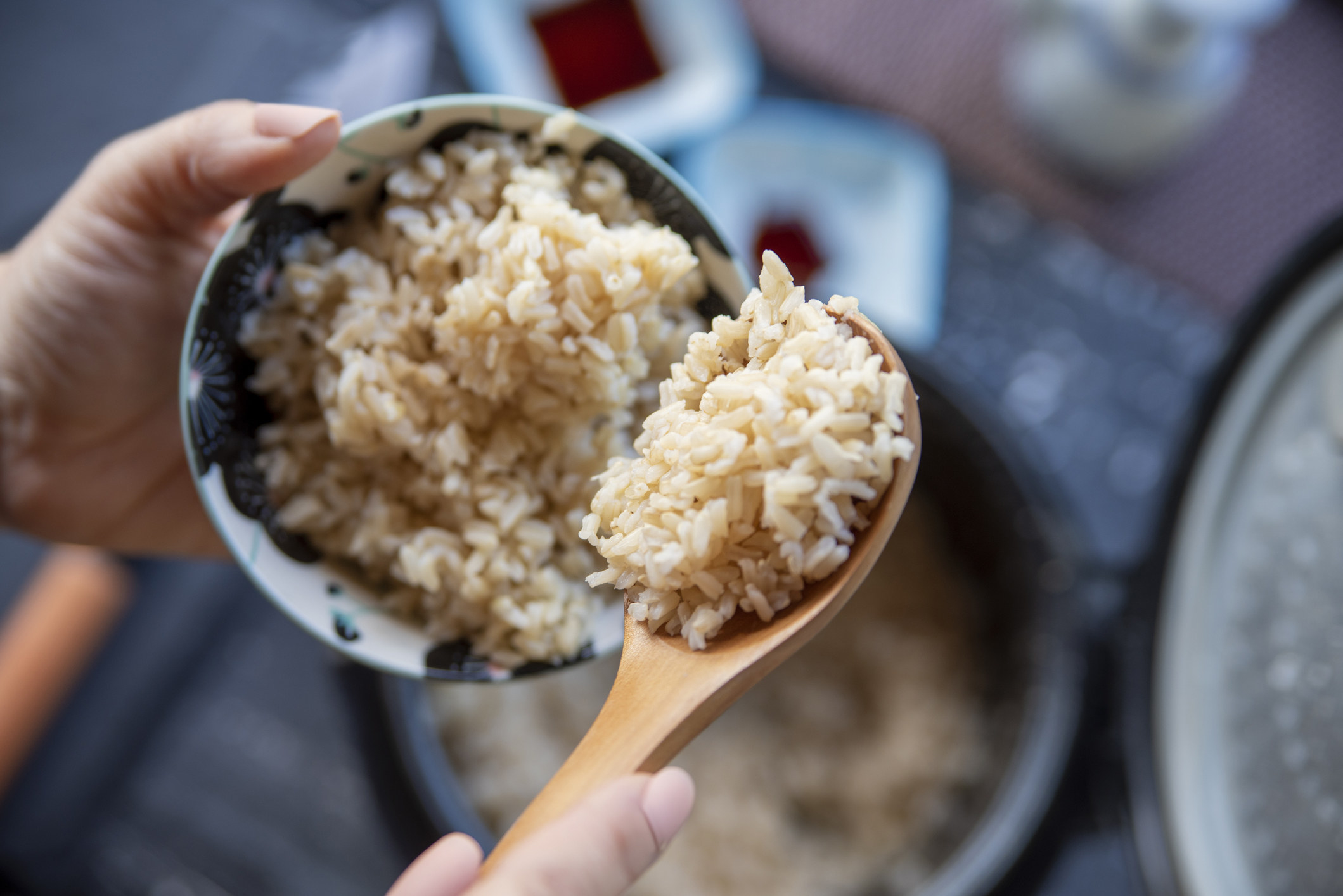 Spooning rice into a bowl.