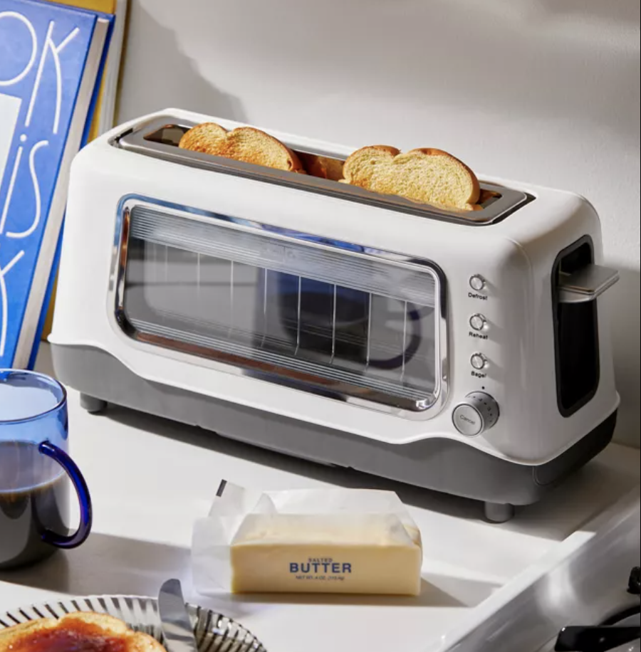 a toaster with a window on the front and a piece of toast inside