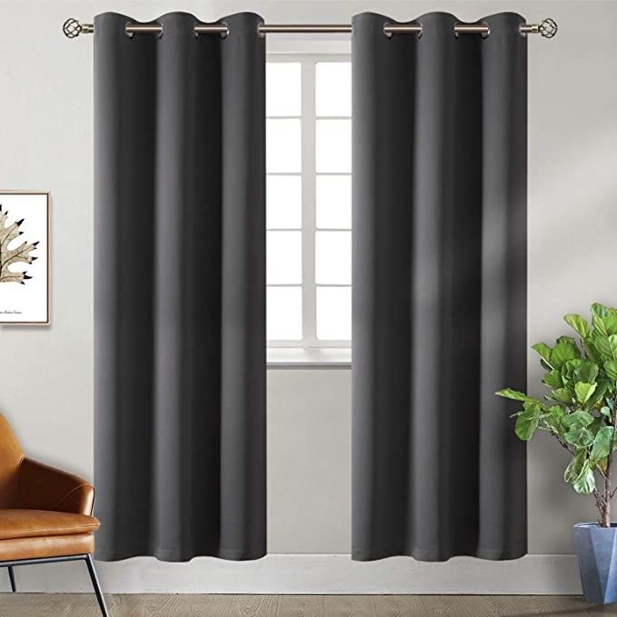 a set of curtains hanging over a window in a living room