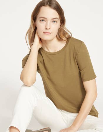 a model wearing the tee in green