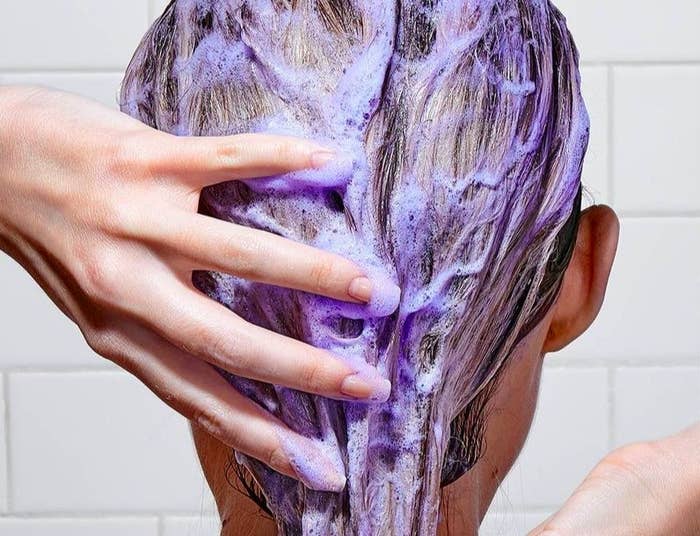 Model washing their hair with purple shampoo