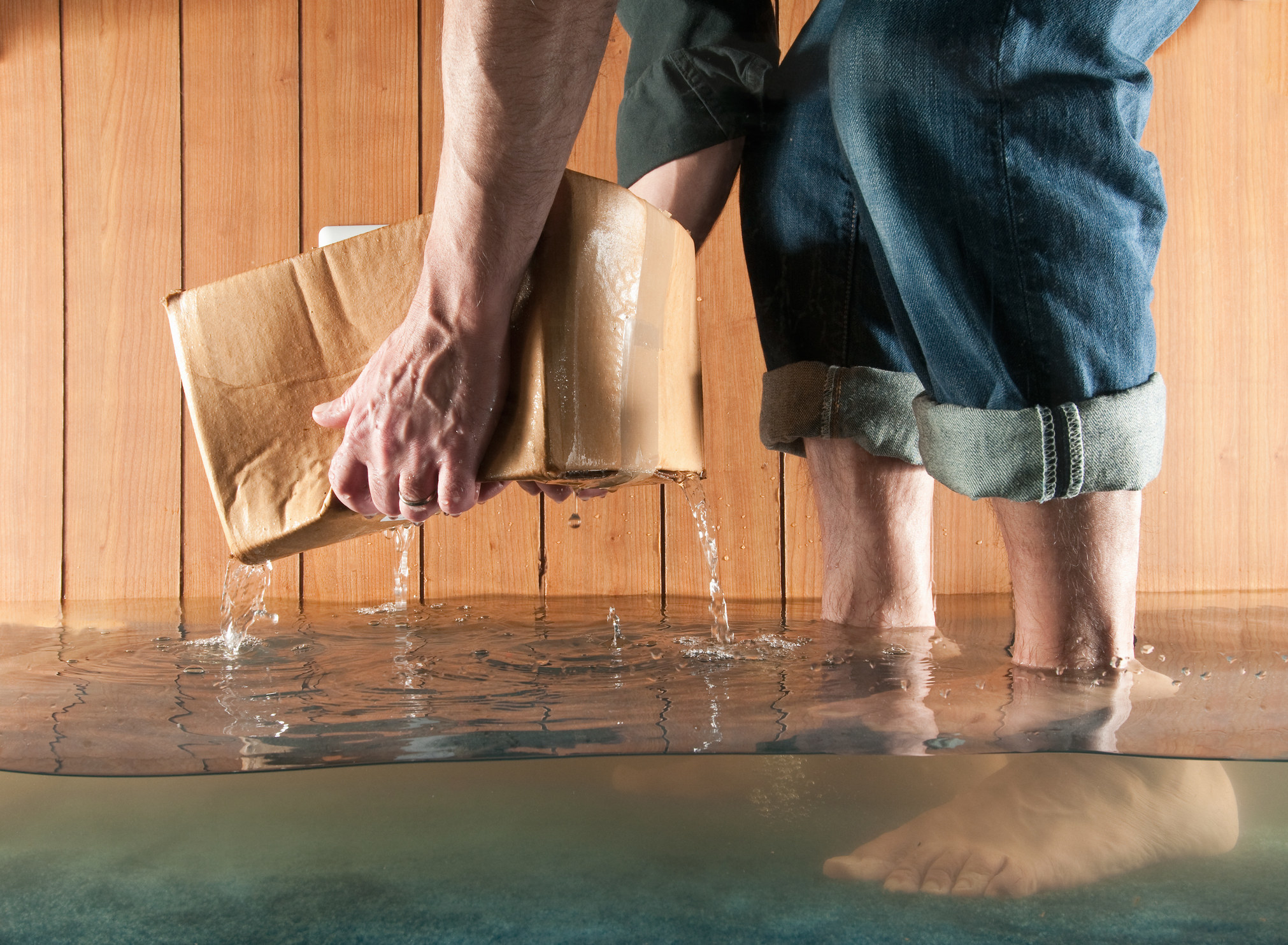 someone getting a wet box out of a flooded area