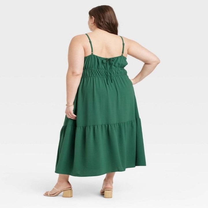 A model wearing a green midi dress