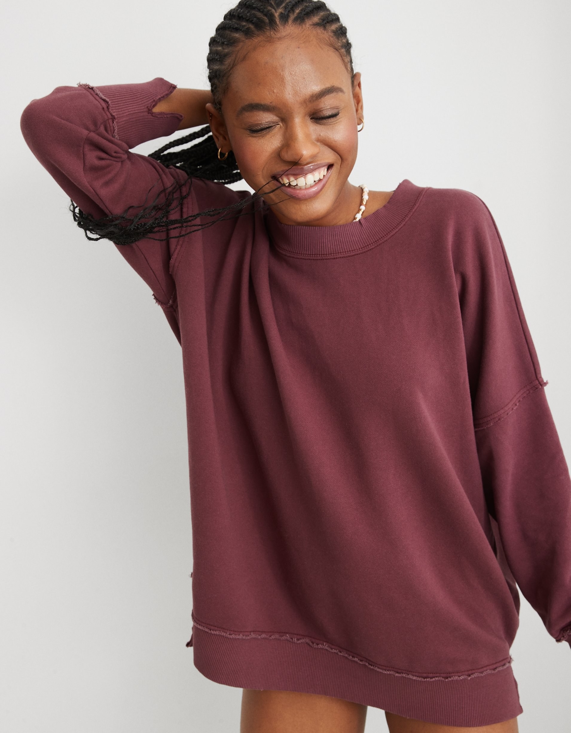 model in maroon oversized crewneck tee with distressed seams