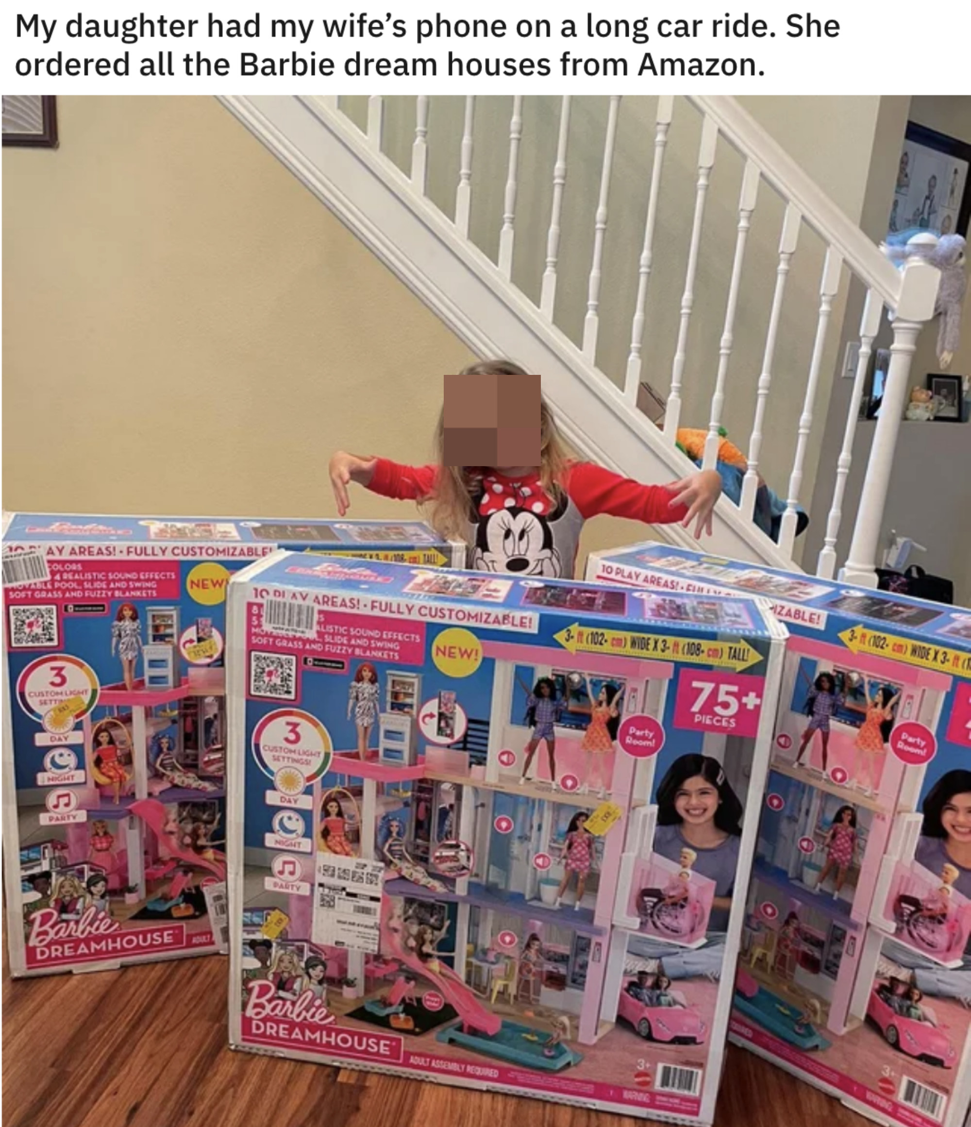 kid with three Barbie dreamhouses