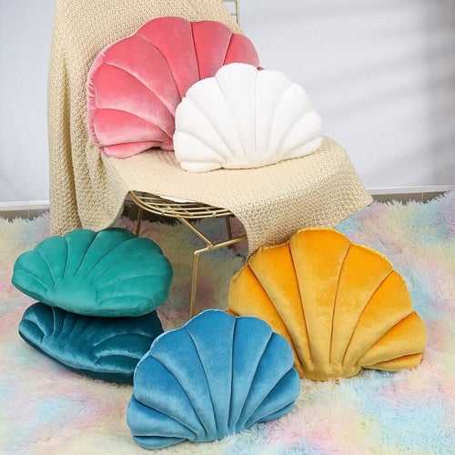 a variety of shell pillows in different colors such as blue yellow pink and white