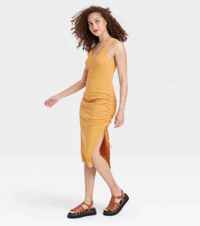 A model wearing a yellow ruched knit dress