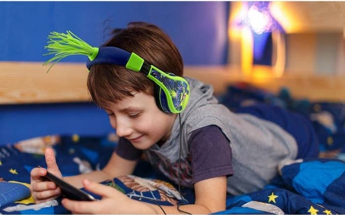Boy with headphones laying down
