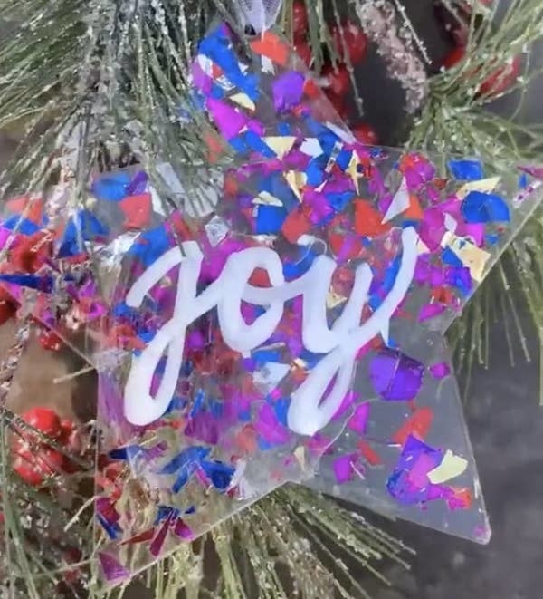Clear star-shaped ornaments with decorations and writing added