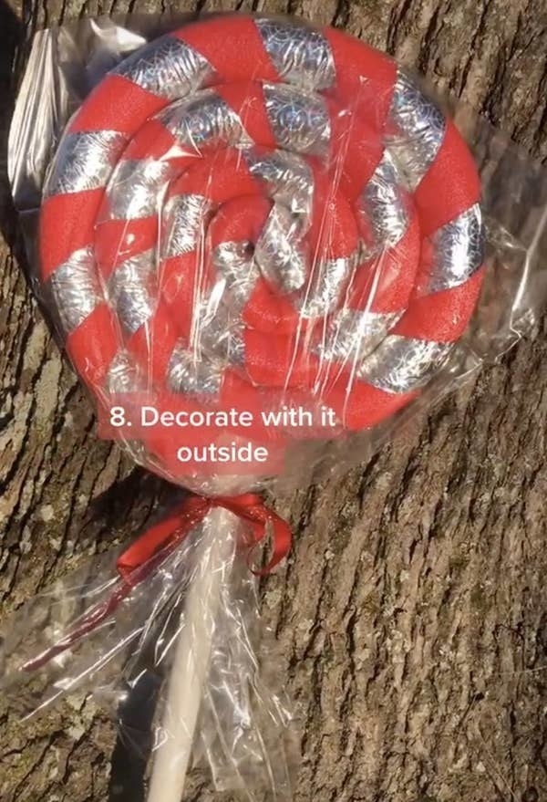 A coiled pool noodle on a stick with ribbon