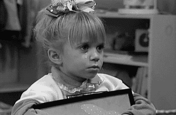 Gif in black and white of Michelle Tanner from Full House shedding a tear