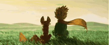 The Little Prince sits in the wind looking out on a field