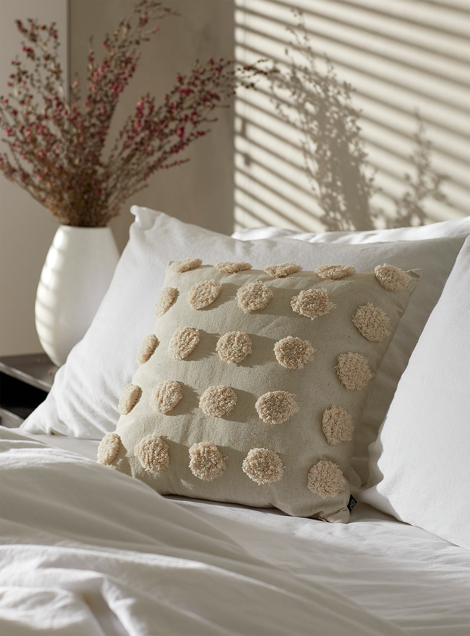 a tufted throw with textured polkadots on it