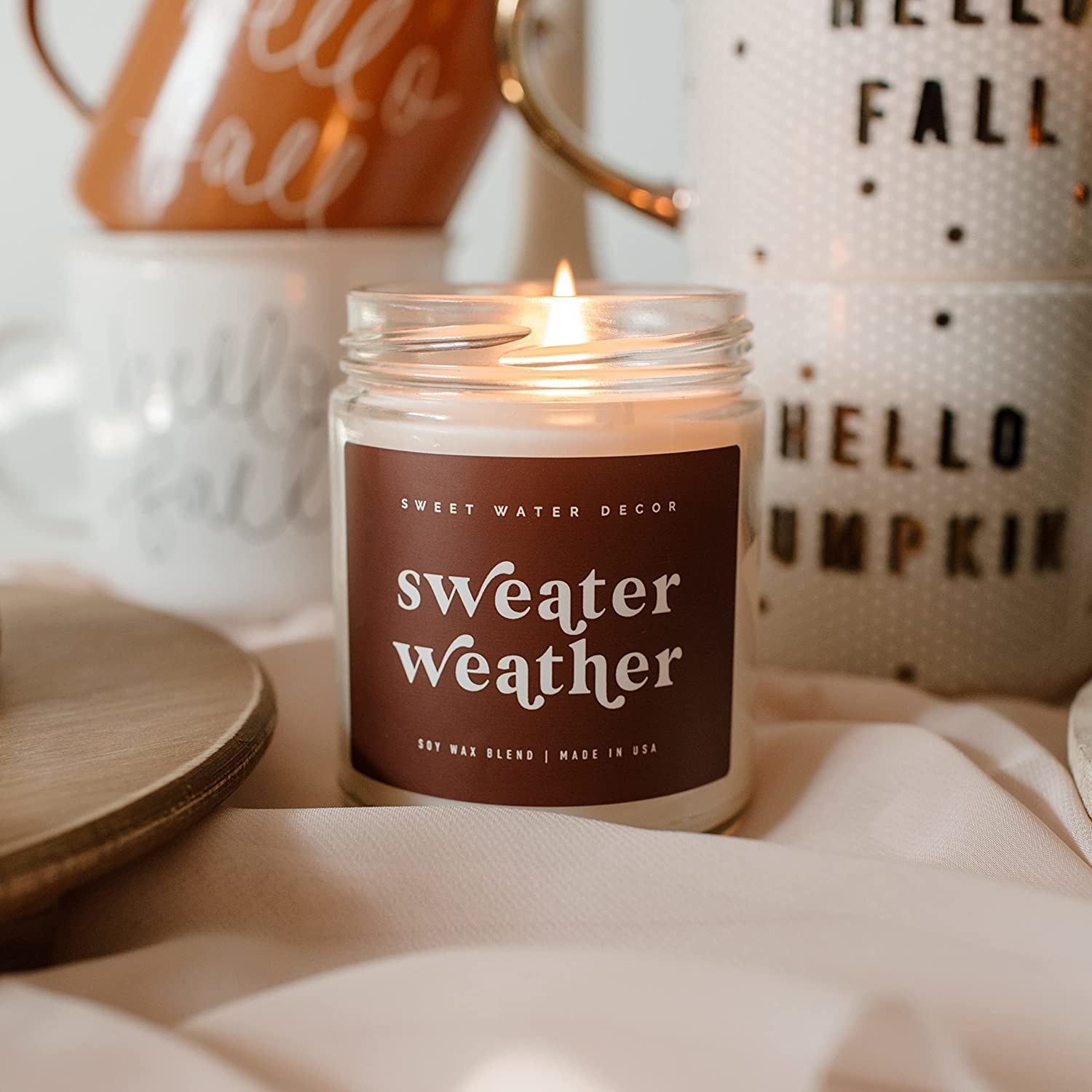 the sweater weather candle lit and burning