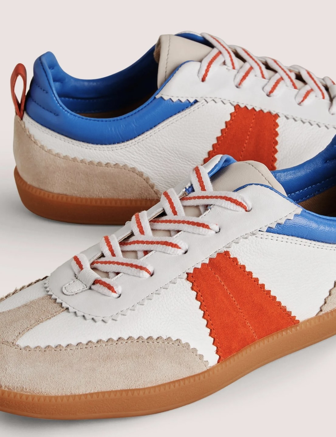 The red, blue, white, and beige block trainers