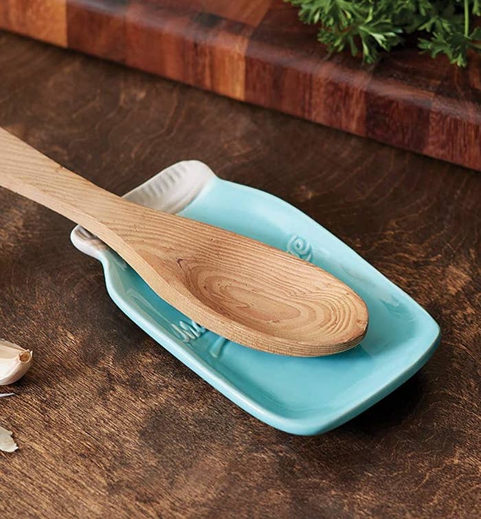 A wooden spoon on the spoon rest