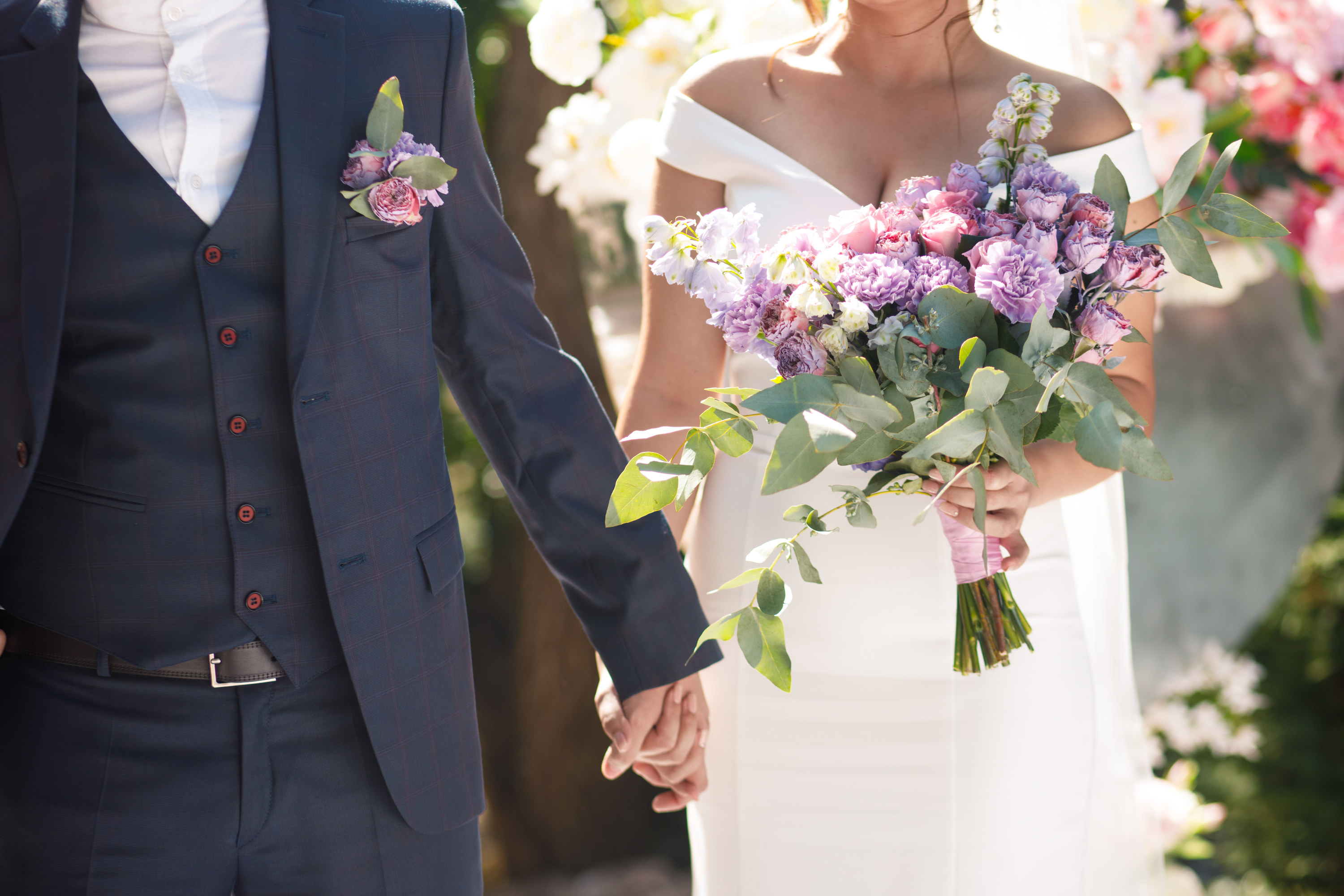 a bride and groom walking down the aisle holding hands