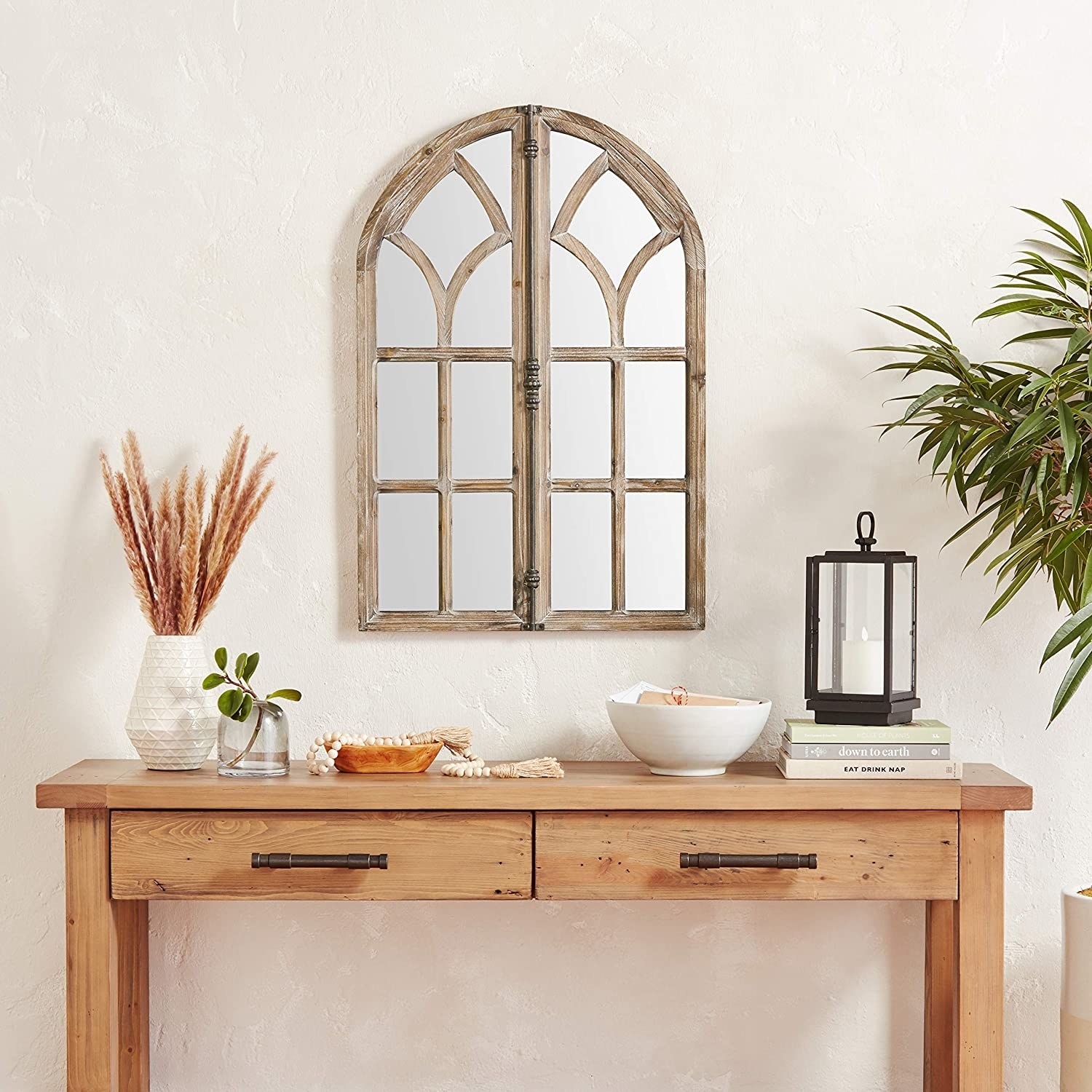 the mantel mirror above a wall table