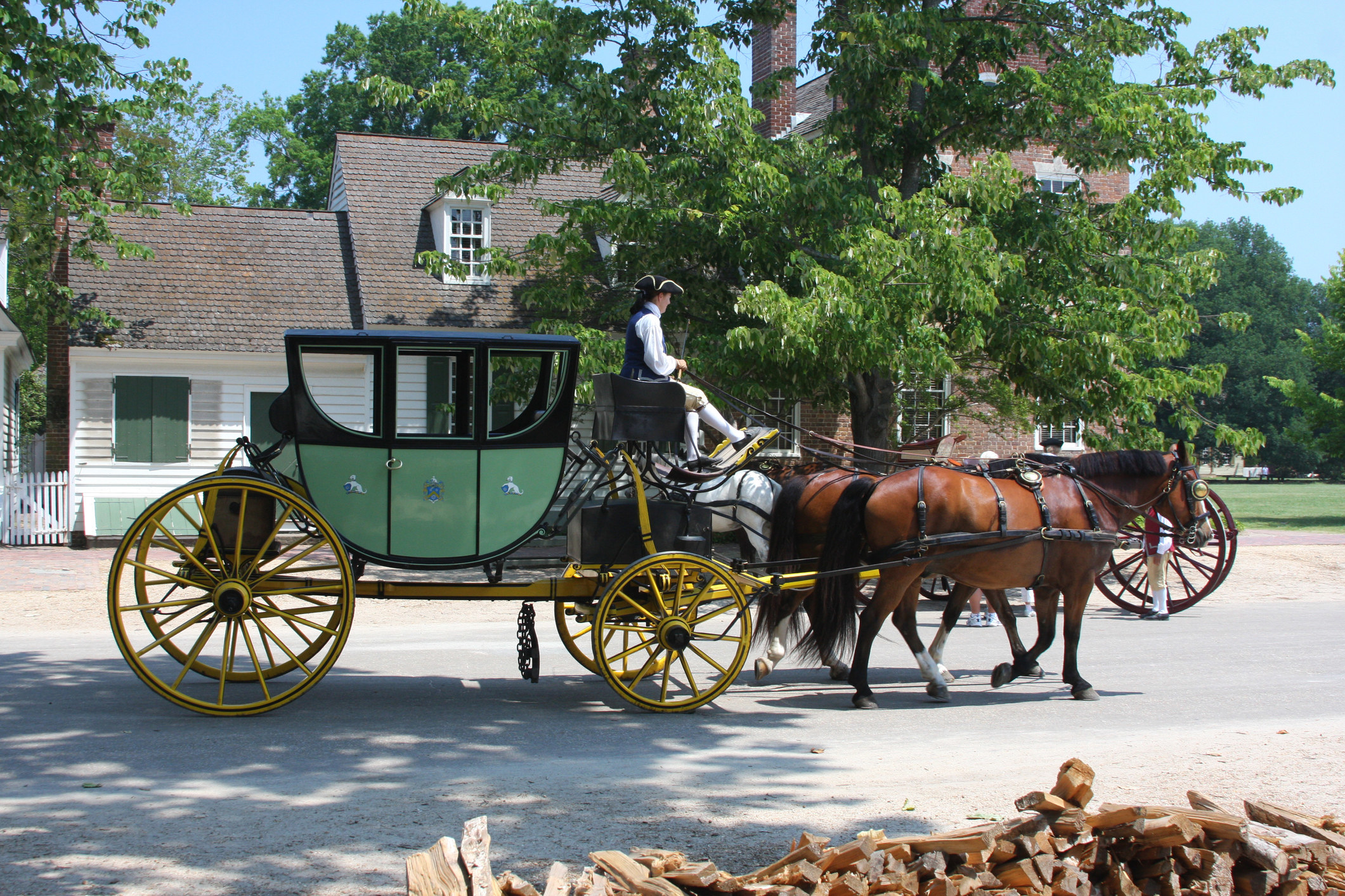 A horse-drawn carriage heads down the street