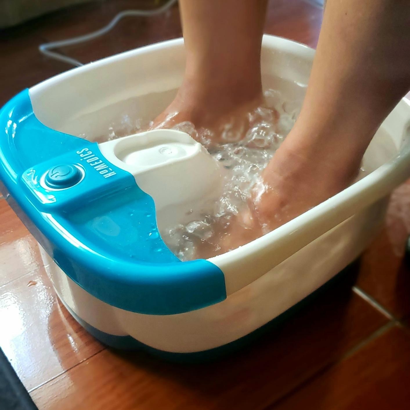 Reviewer using the foot spa with bubbling water inside