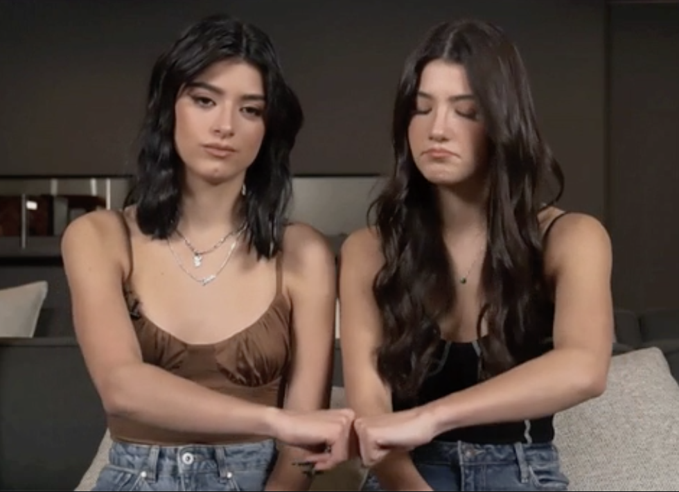 two sisters putting their fists to each other in agreement