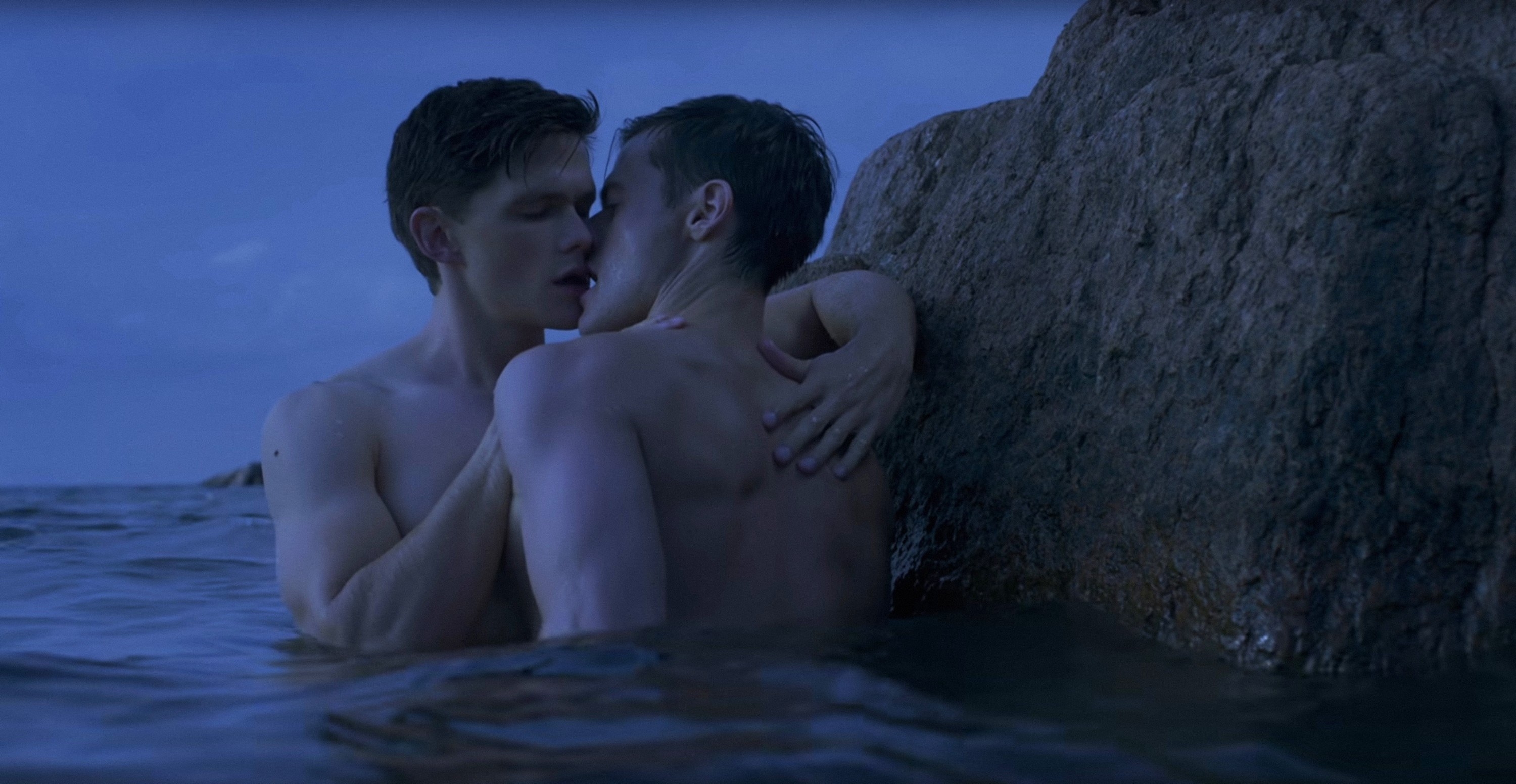 Tom Prior and Oleg Zagorodni kiss by a rock