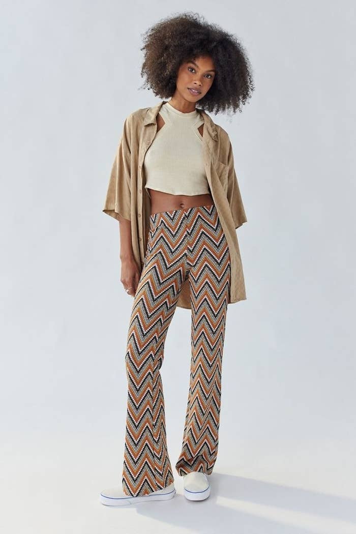 model wearing the pants in orange and black chevron print