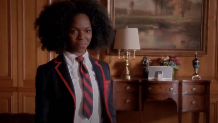 Samantha Ware wearing a school uniform, including a tie, in a scene from Glee