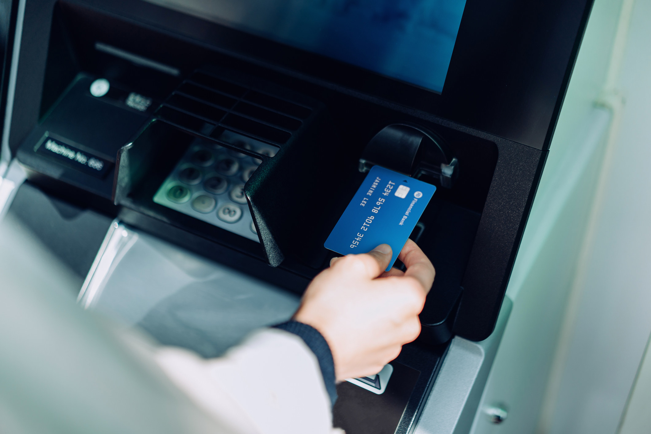 hand using an atm