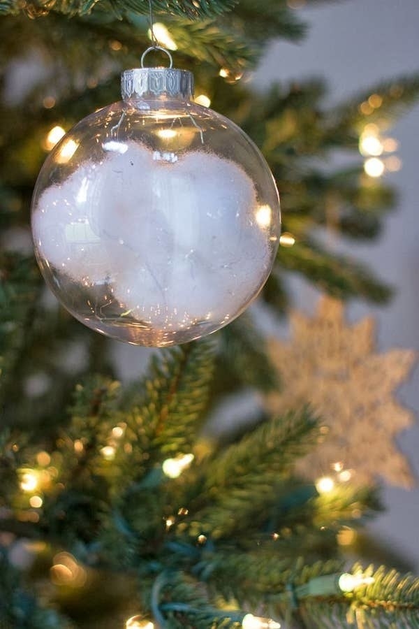 Ball ornament with &quot;snow&quot; inside hanging from a tree