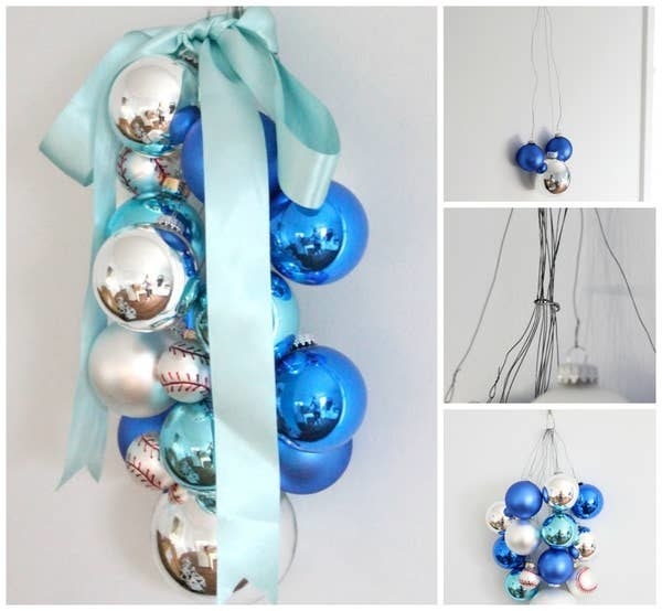 Ball ornaments with a ribbon hanging from wires on a wall