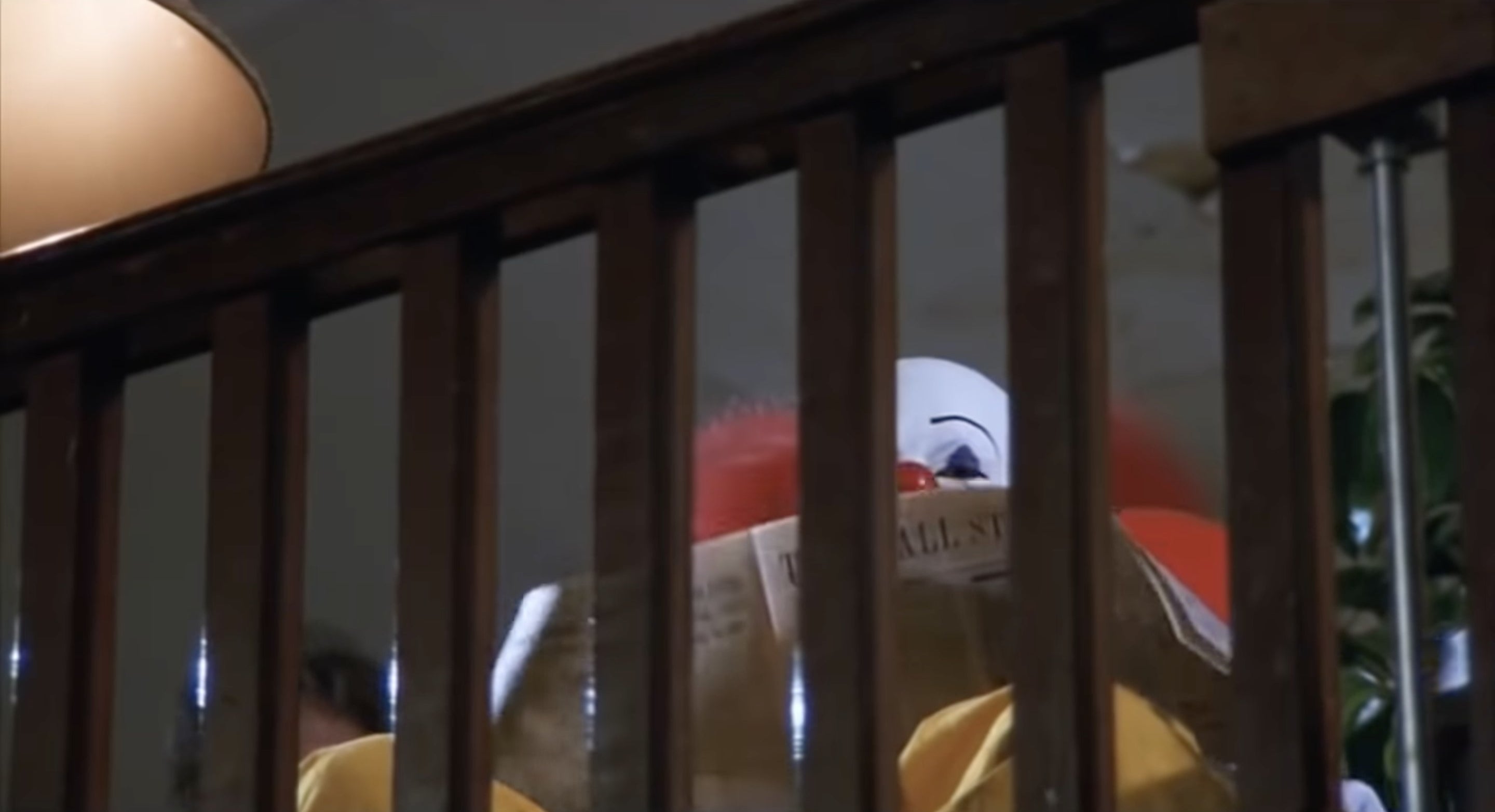 A clown reading a newspaper