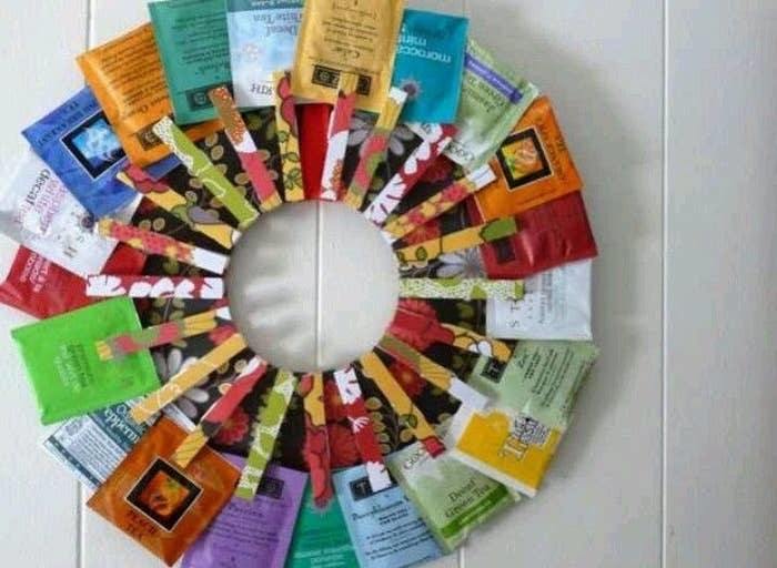 A colorful wreath made out of individual tea bag packages attached to it