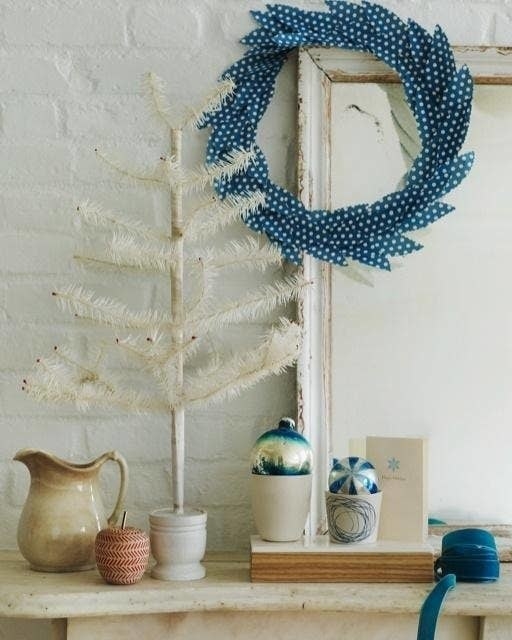 A blue and white dot fabric frayed and in the shape of a wreath