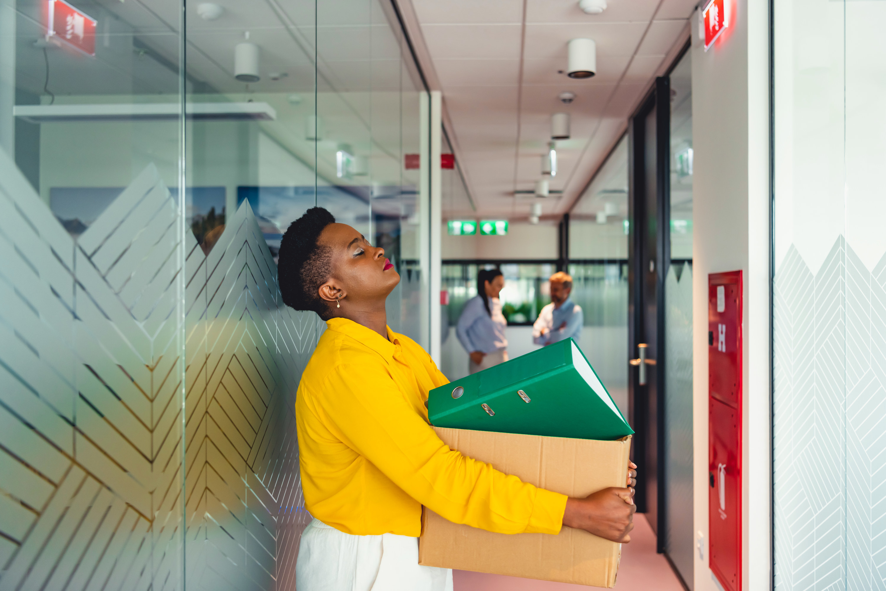 woman leaving an office after being let go