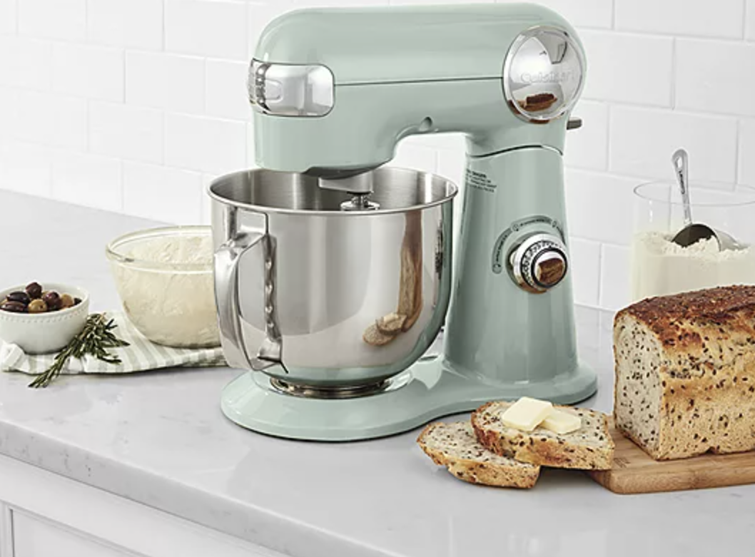 mint Cuisinart stand mixer on table next to fresh loaf of bread and olives in dish